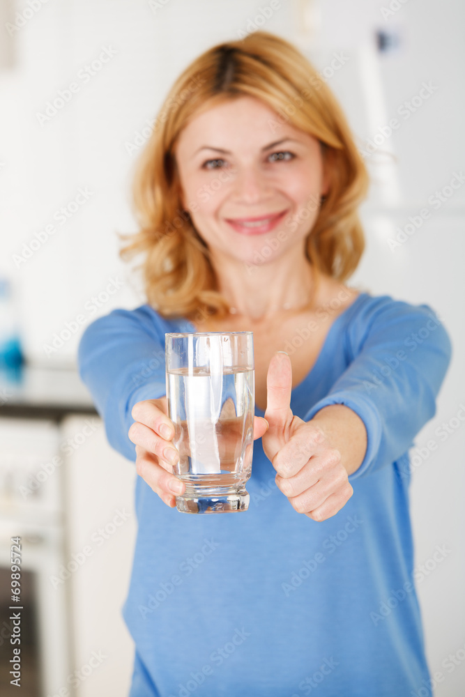 Beautiful woman holding a glass of water Beautiful woman holding a glass of water