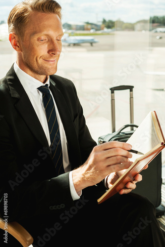 Businessman making notes. © gstockstudio