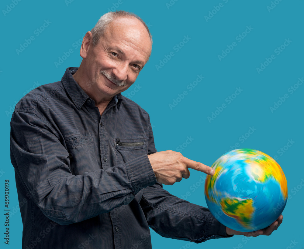 Senior smiling man standing with world globe Senior smiling man standing with world globe