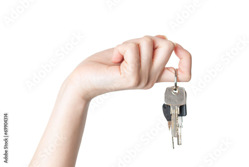 female hand holding a key isolated