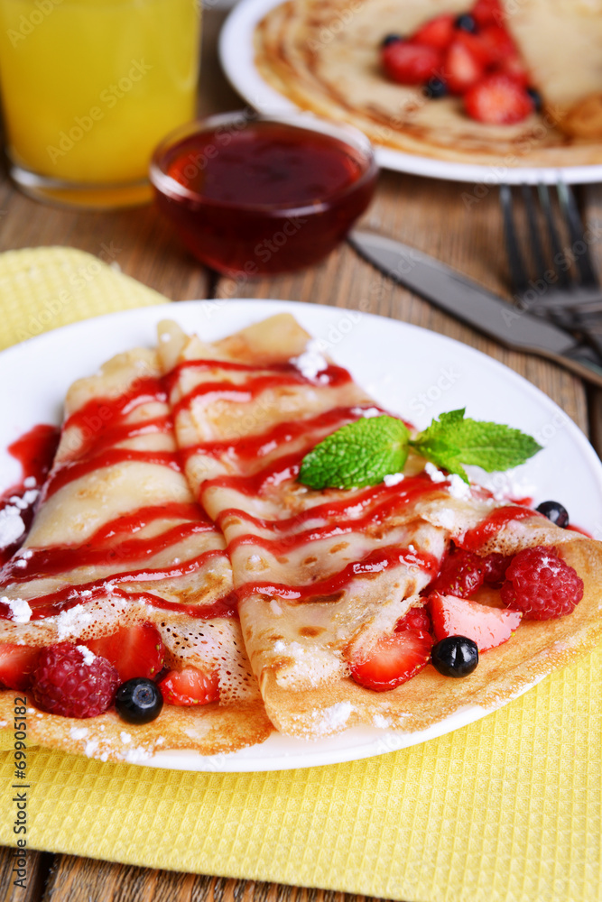 Delicious pancakes with berries on table close-up Delicious pancakes with berries on table close-up