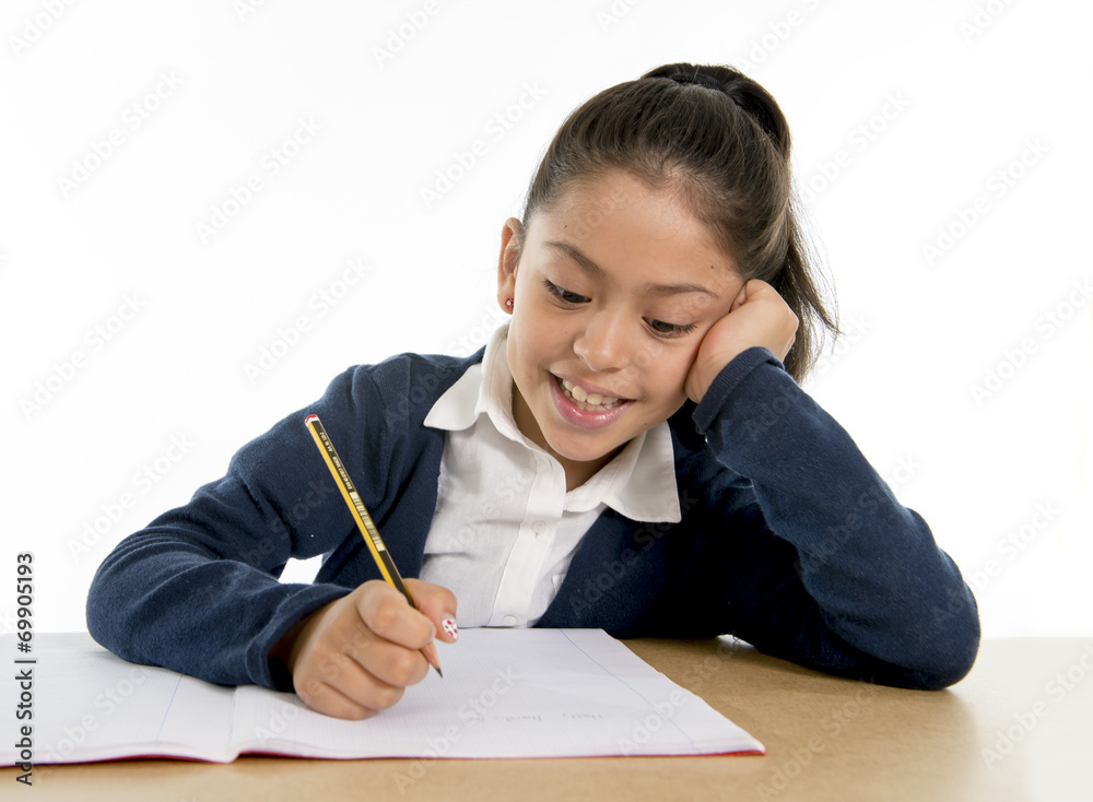 happy hispanic little school girl writing in education concept happy hispanic little school girl writing in education concept