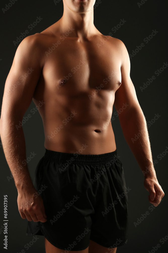 Handsome muscle young man on dark background Handsome muscle young man on dark background