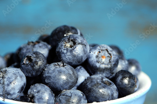 Tasty ripe blueberries, on wooden background