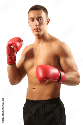 Handsome young muscular sportsman with boxing gloves isolated © Africa Studio