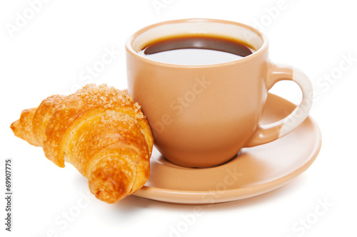 Cup of coffee with a croissant