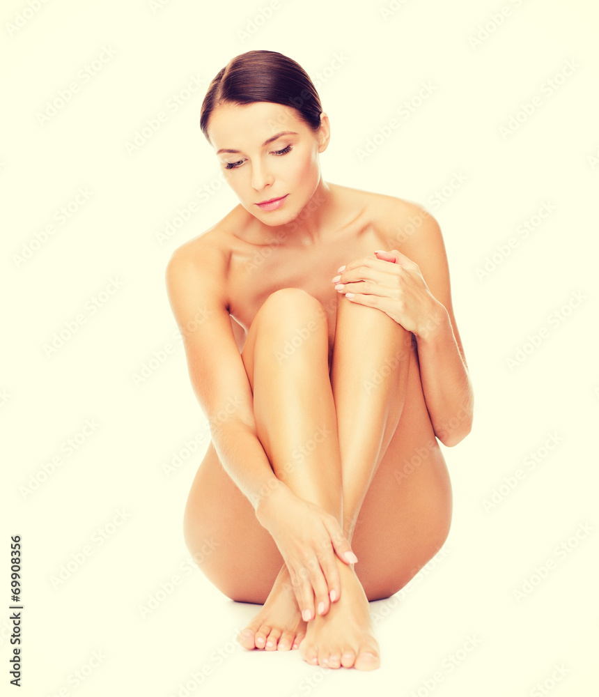Obraz premium beautiful naked woman touching her legs