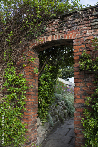 Brick, garden doorway in English garden in England