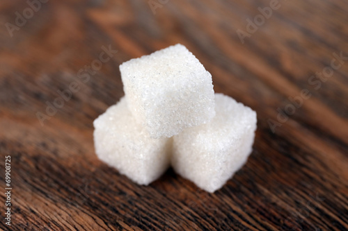 White refined sugar on wooden background