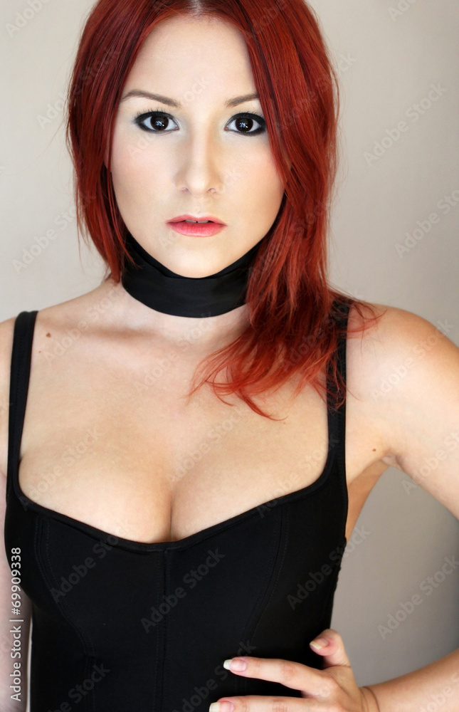 Sexy redhead girl in black corset with black ribbon on the neck Stock Photo  | Adobe Stock