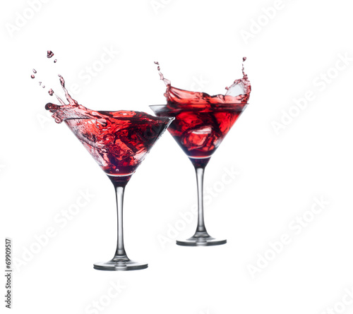 full martini glass with red cocktail fnd splashes isolated on