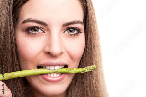 Girl biting asparagus