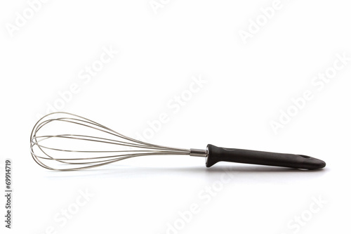 Metal whisk for whipping eggs on white background.
