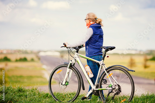 Girl with bike on hill