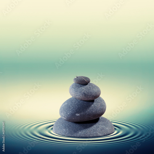 Wet pebble in the water   alternative medicine concept