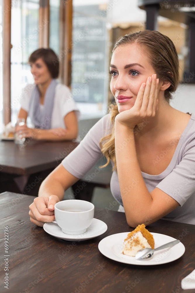 Pretty blonde enjoying cake and coffee