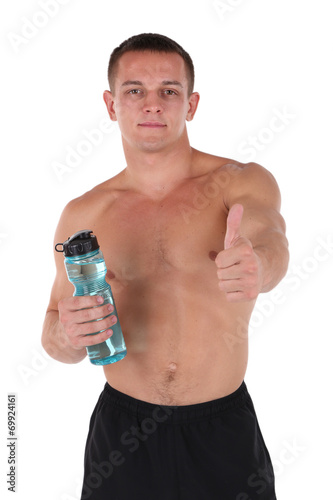 Handsome young sportsman holding bottle with water isolated