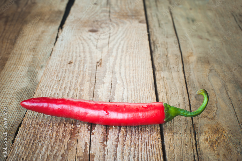 Juicy and spicy peppers on a wooden rustic table Juicy and spicy peppers on a wooden rustic table