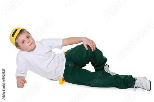 Fashion handsome young boy is lying on the white