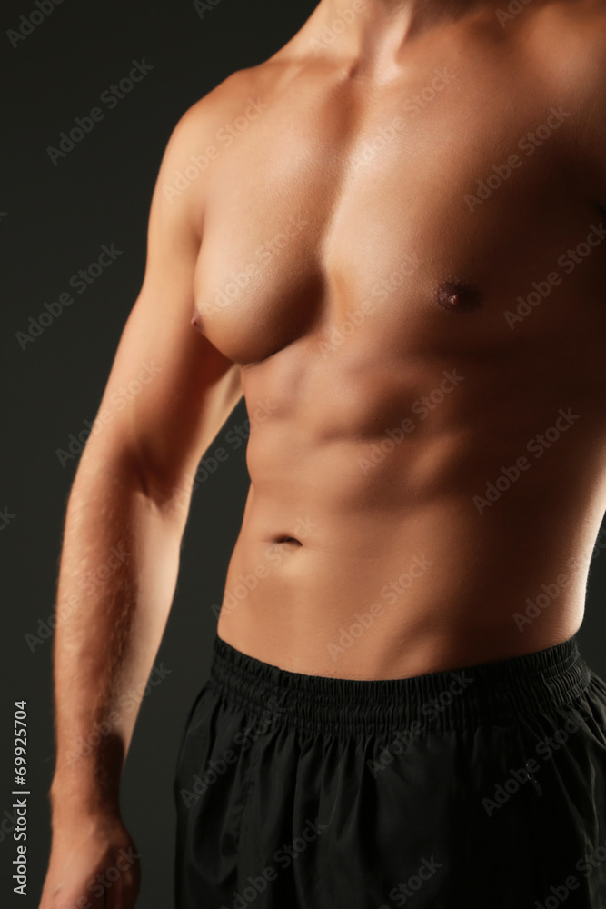 Handsome muscle young man on dark background