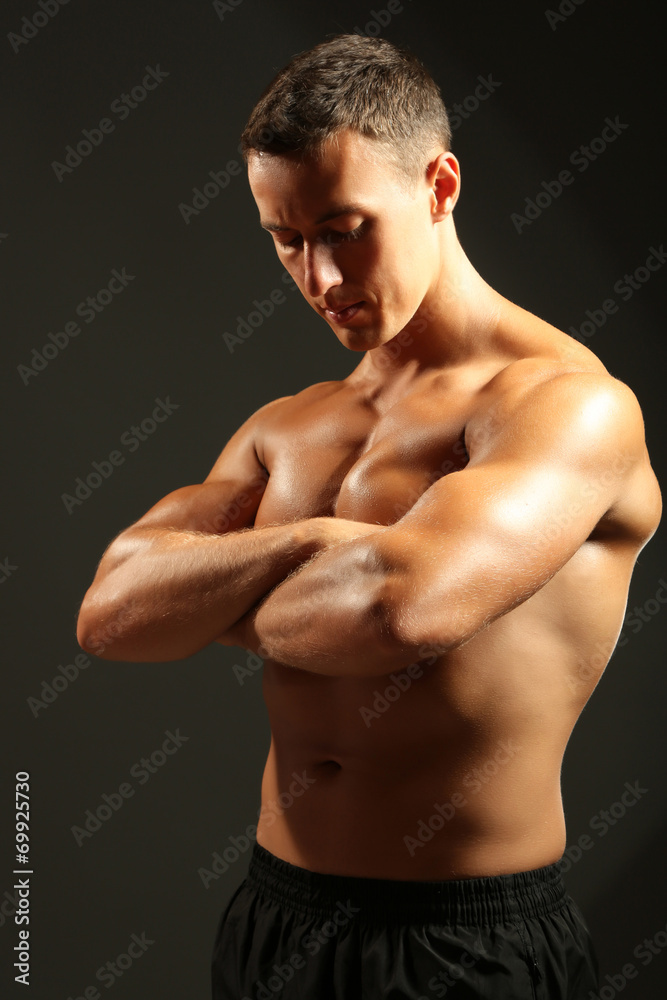 Handsome muscle young man on dark background Handsome muscle young man on dark background