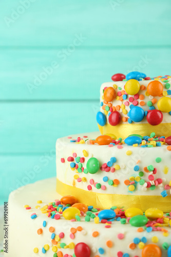 Beautiful tasty birthday cake on color wooden background