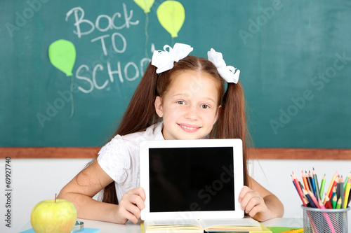 Cute girl with tablet at wo...