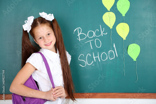 Cute girl standing near bla...