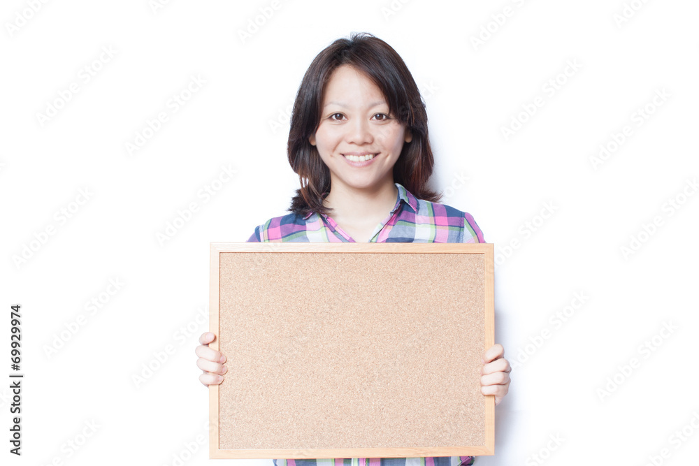 Young smiling Japanese woman holding a cork board Young smiling Japanese woman holding a cork board