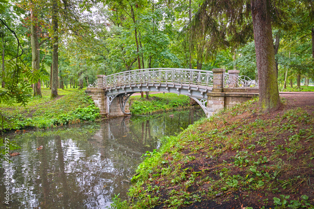 Ancient bridge over flow in the park Ancient bridge over flow in the park