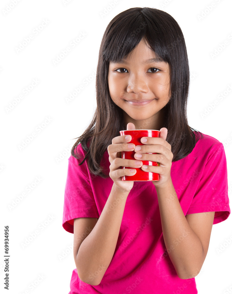 Young Asian preteen girl with a red mug over white background Young Asian preteen girl with a red mug over white background