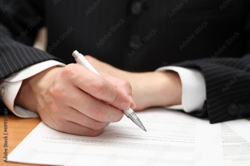 Businessman viewing the contract before signing Businessman viewing the contract before signing