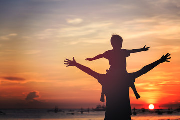 father and son on sunset beach