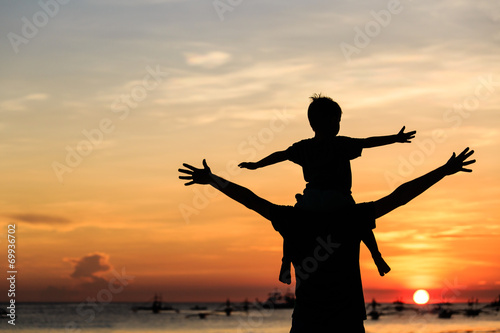 father and son on sunset beach