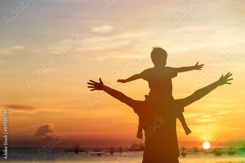 father and son on sunset beach