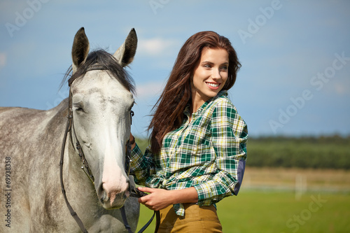 Woman with a white horse outdoor