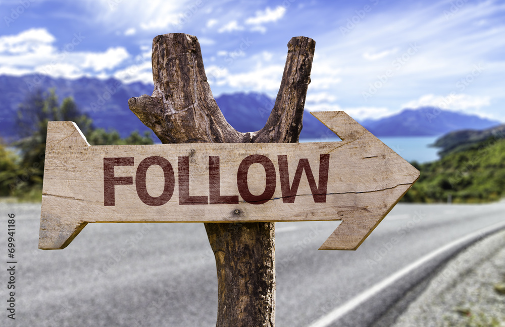 Follow wooden sign with a road background