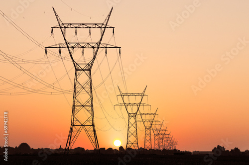 High voltag pylon in landscape during sunset photo