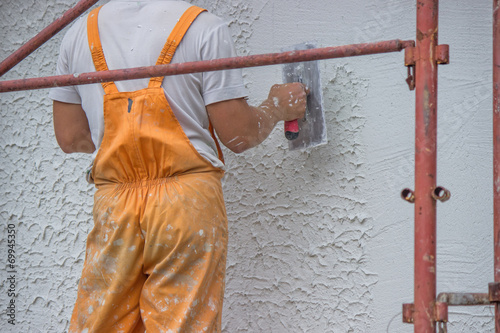 Plasterer applying a finish coating to a wall 2