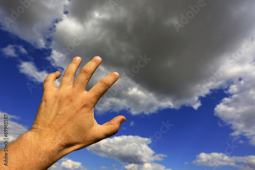 man hand on sky background
