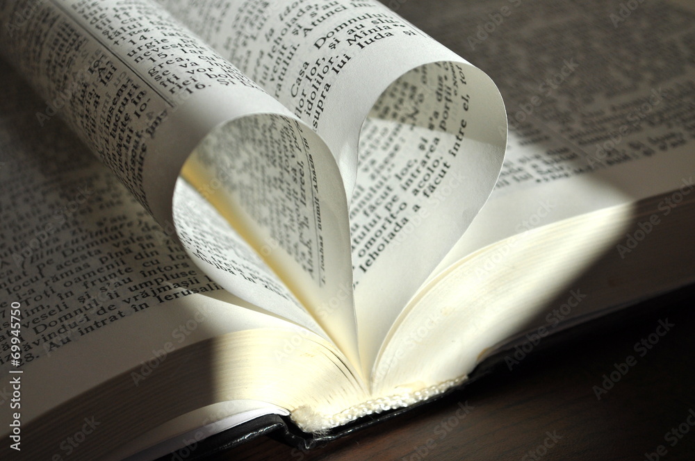 Fototapeta premium Closeup pages of an open book, with heart shaped pages
