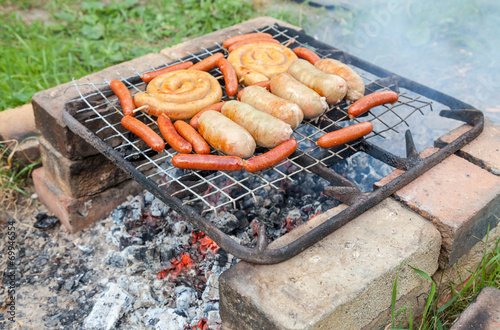 Barbecue with delicious grilled sausages on grill