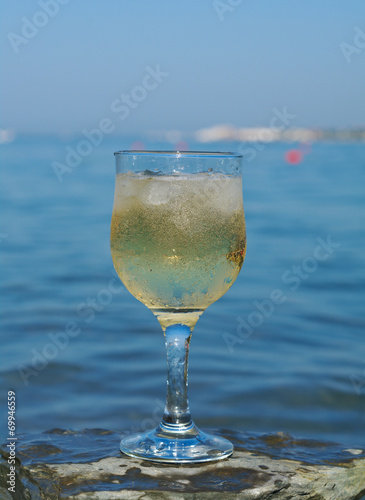 Glass of white wine by the coast