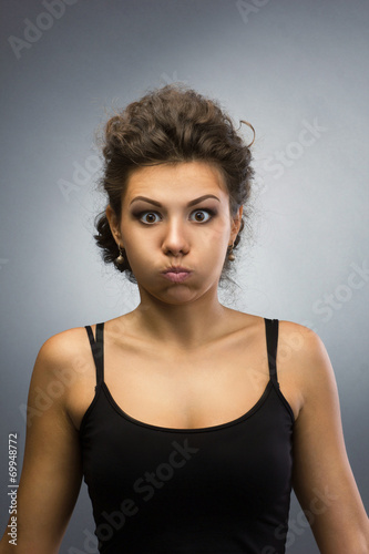 woman with puffing out one's cheeks