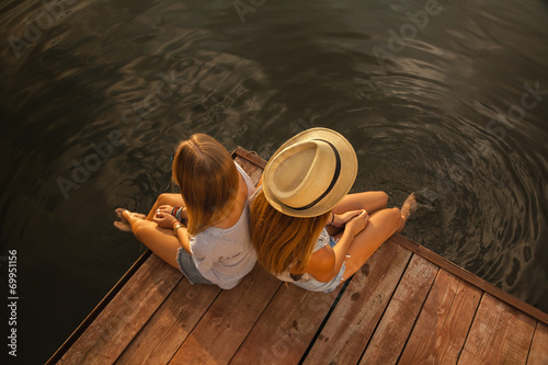 Two Girls Relaxing Near River