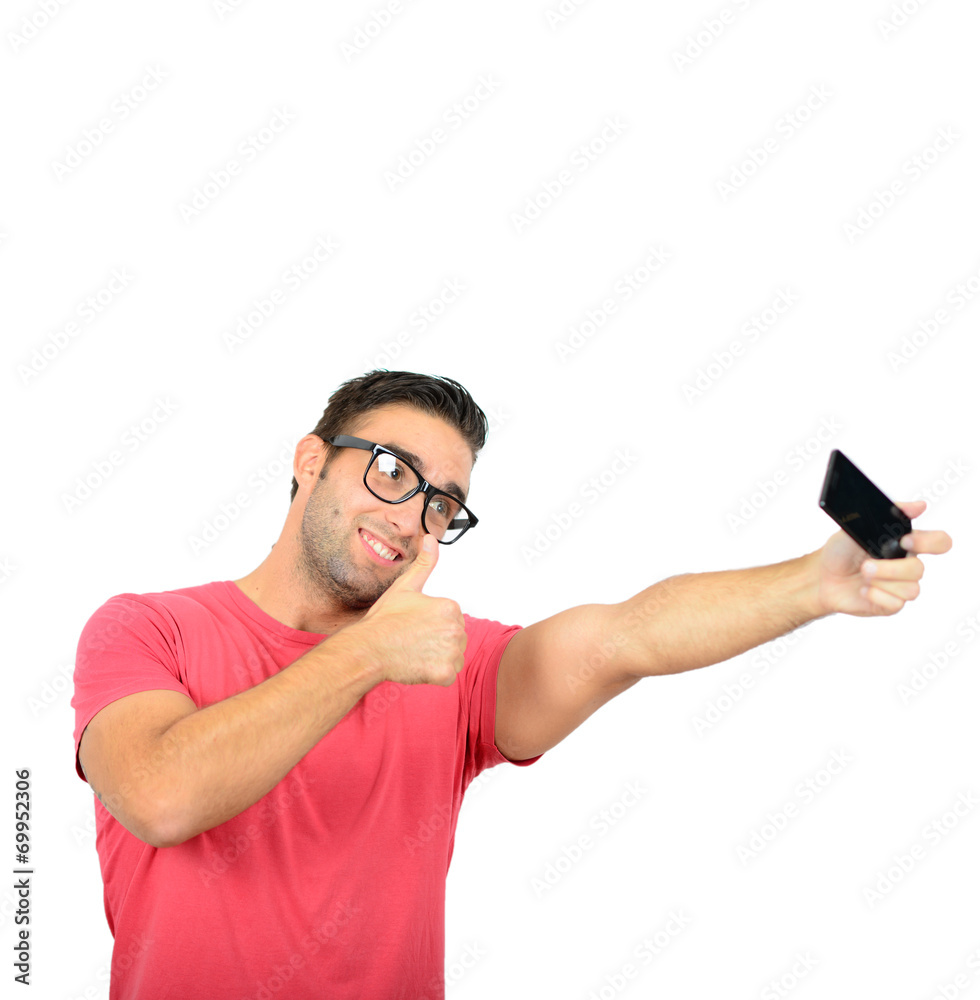 Closeup of young handsome man looking at smartphone and taking s Closeup of young handsome man looking at smartphone and taking s