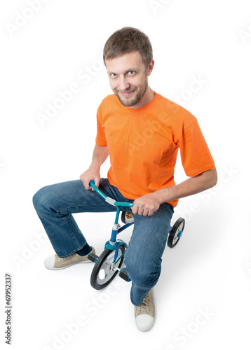 Curious man on a children's bicycle on white background