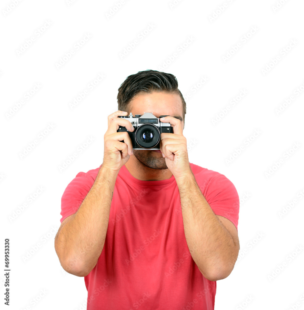 Young man using a retro camera against white background Young man using a retro camera against white background