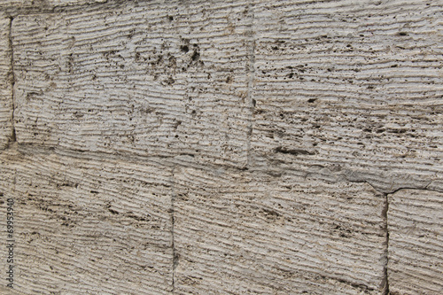 Textured wall of limestone blocks, background