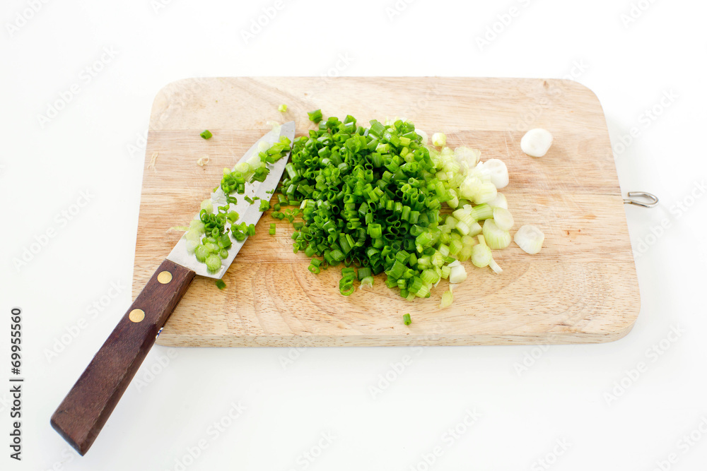 Spring onion on a cutting board with knife Spring onion on a cutting board with knife